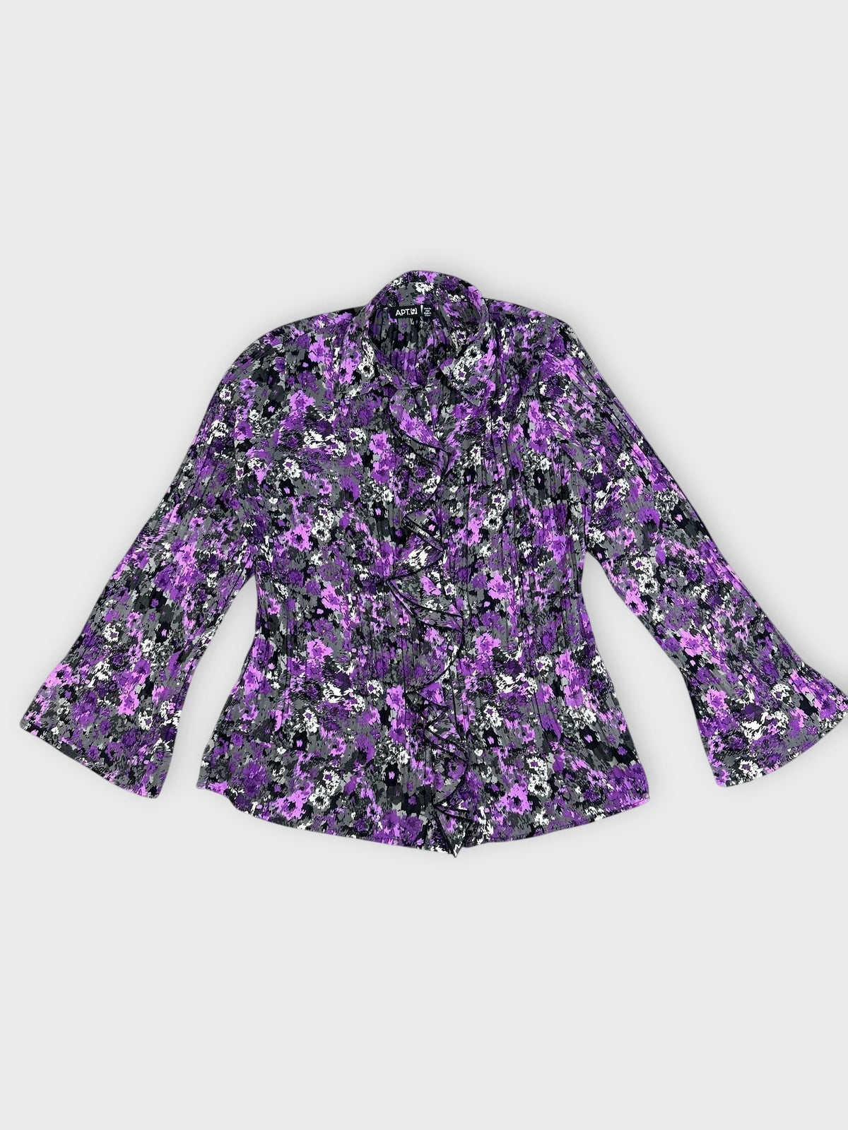 Detail view of a purple floral ruffle blouse with bell sleeves.
