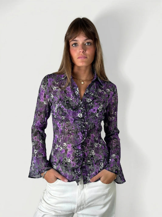 Front view of a purple floral ruffle blouse with bell sleeves.