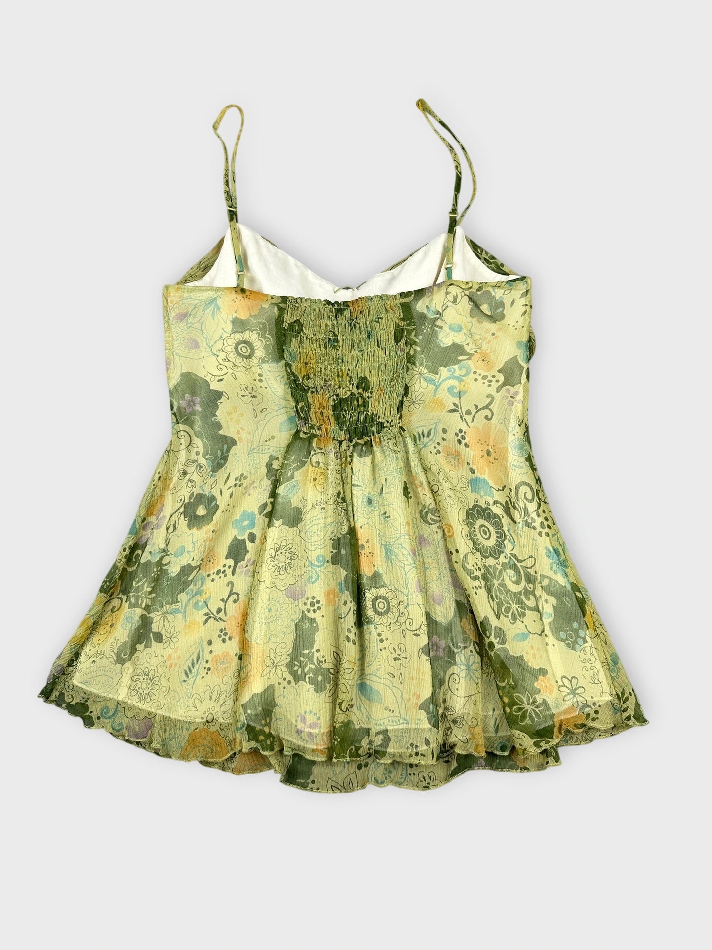 Back view of a green floral silk cami top with a sweetheart neckline.