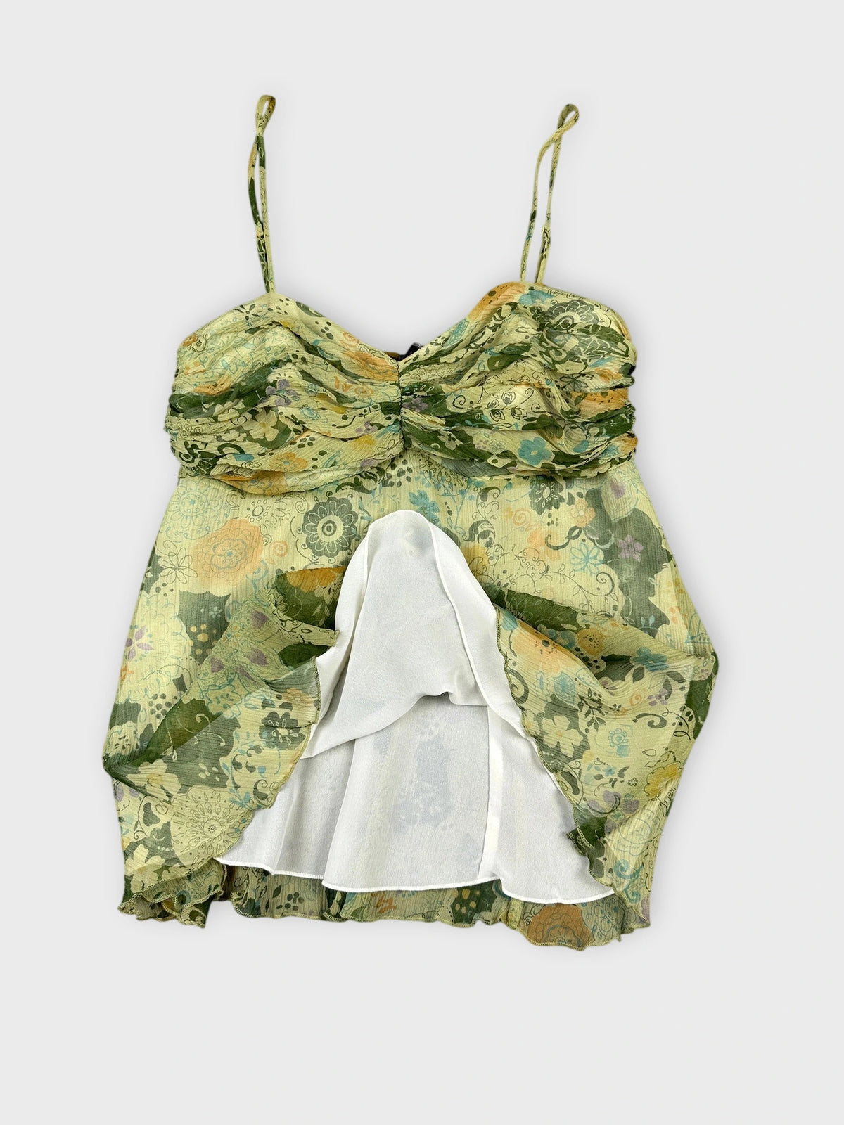 Floral silk cami top in green with sweetheart neckline detail view.