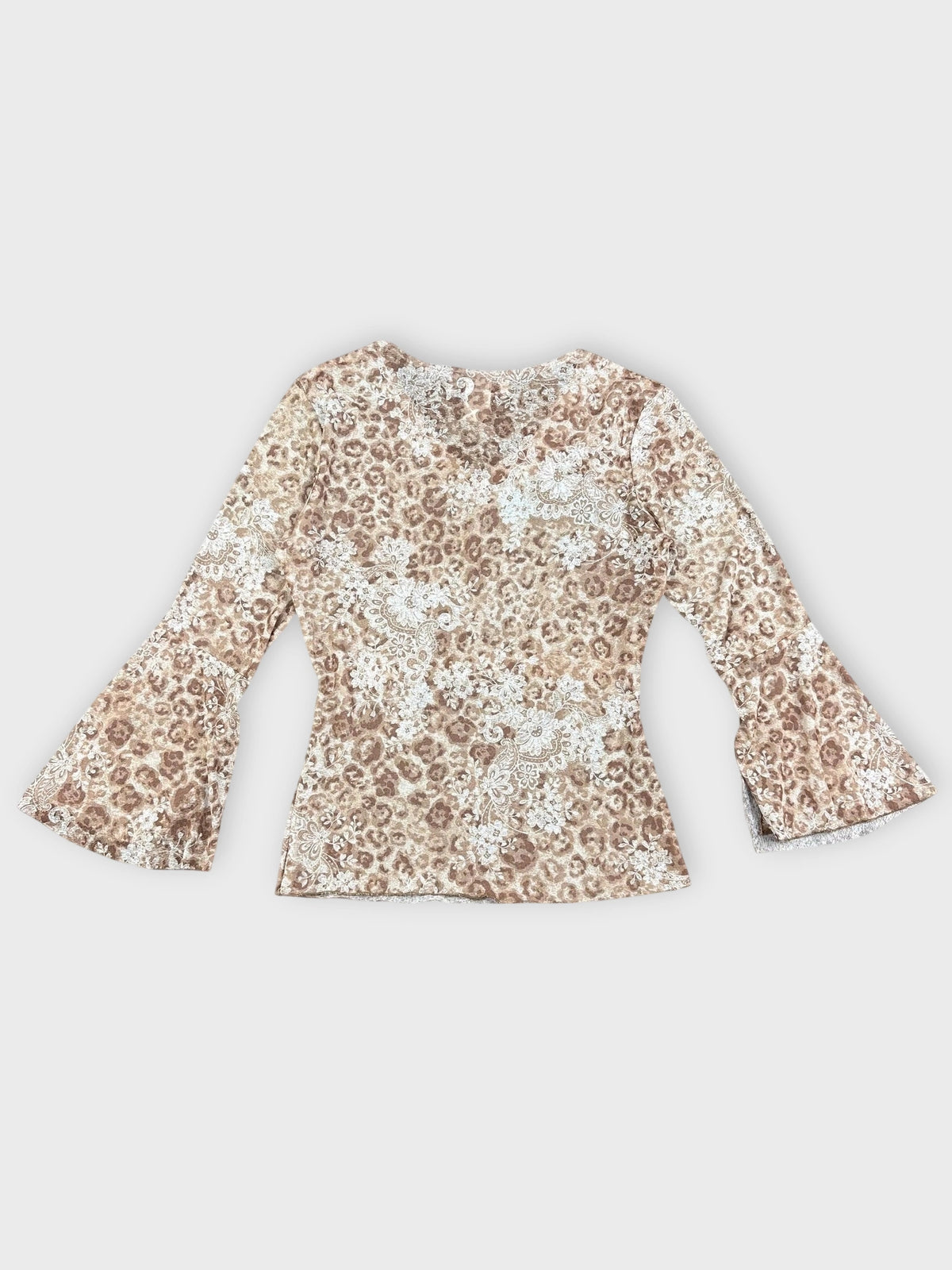 Back view of floral V-neck top with bell sleeves in earthy tones