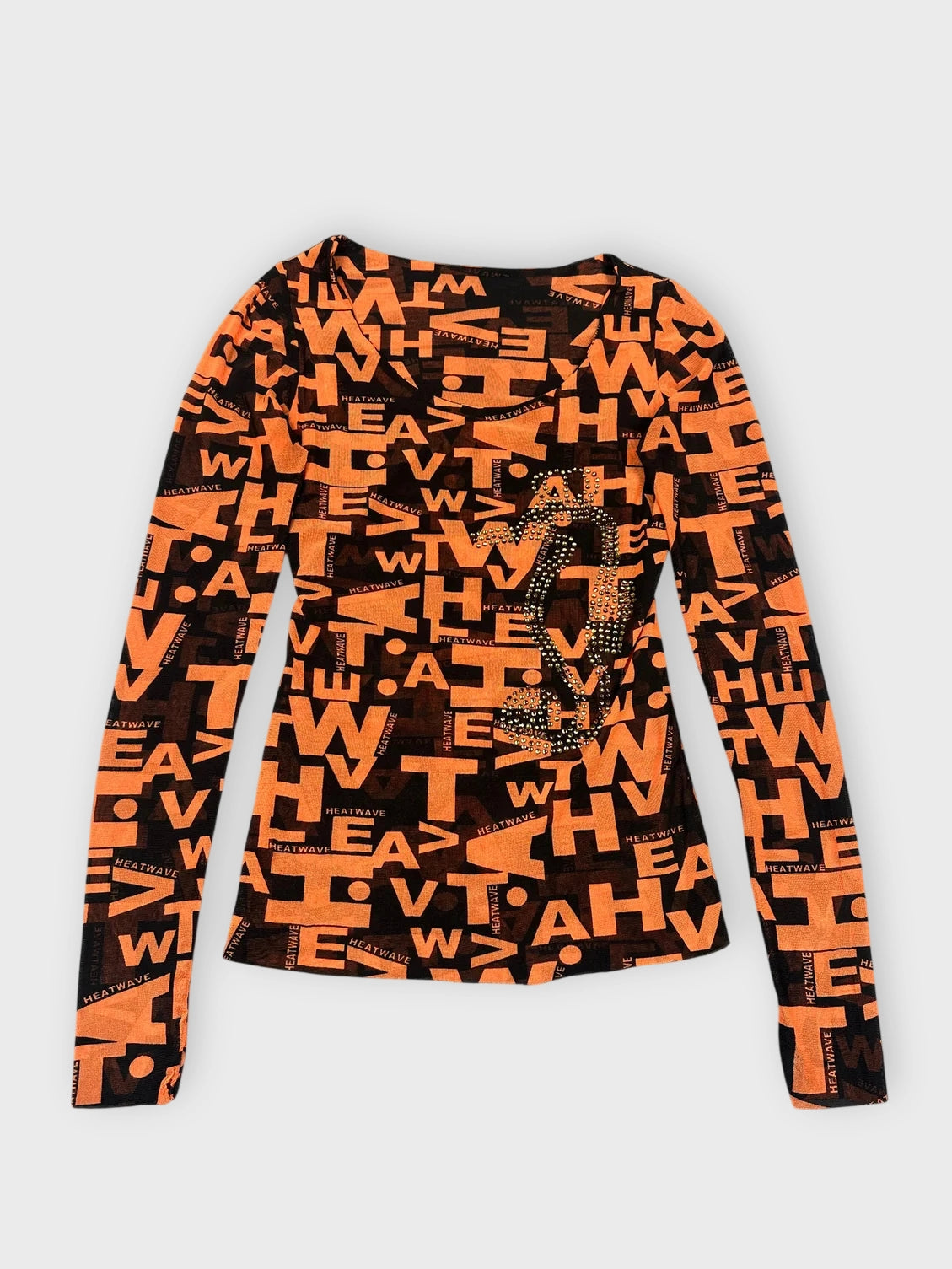 Front view of a bold orange long sleeve top with black graphic prints.