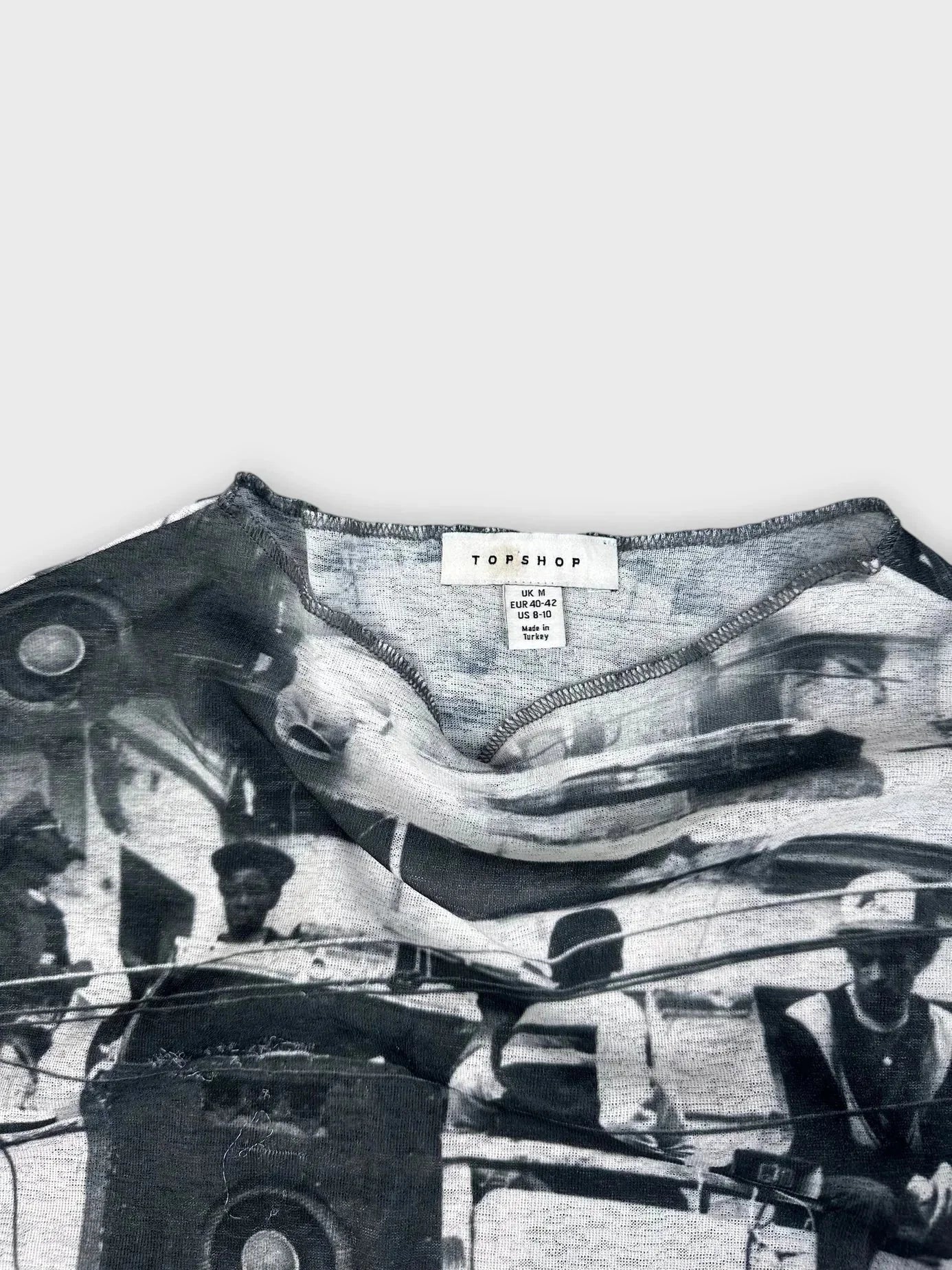 Detail view of a black sleeveless top with graphic print design.