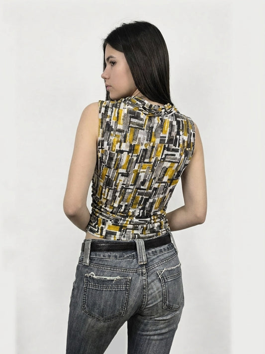 Back view of a sleeveless graphic print top in yellow and gray with ruching detail.
