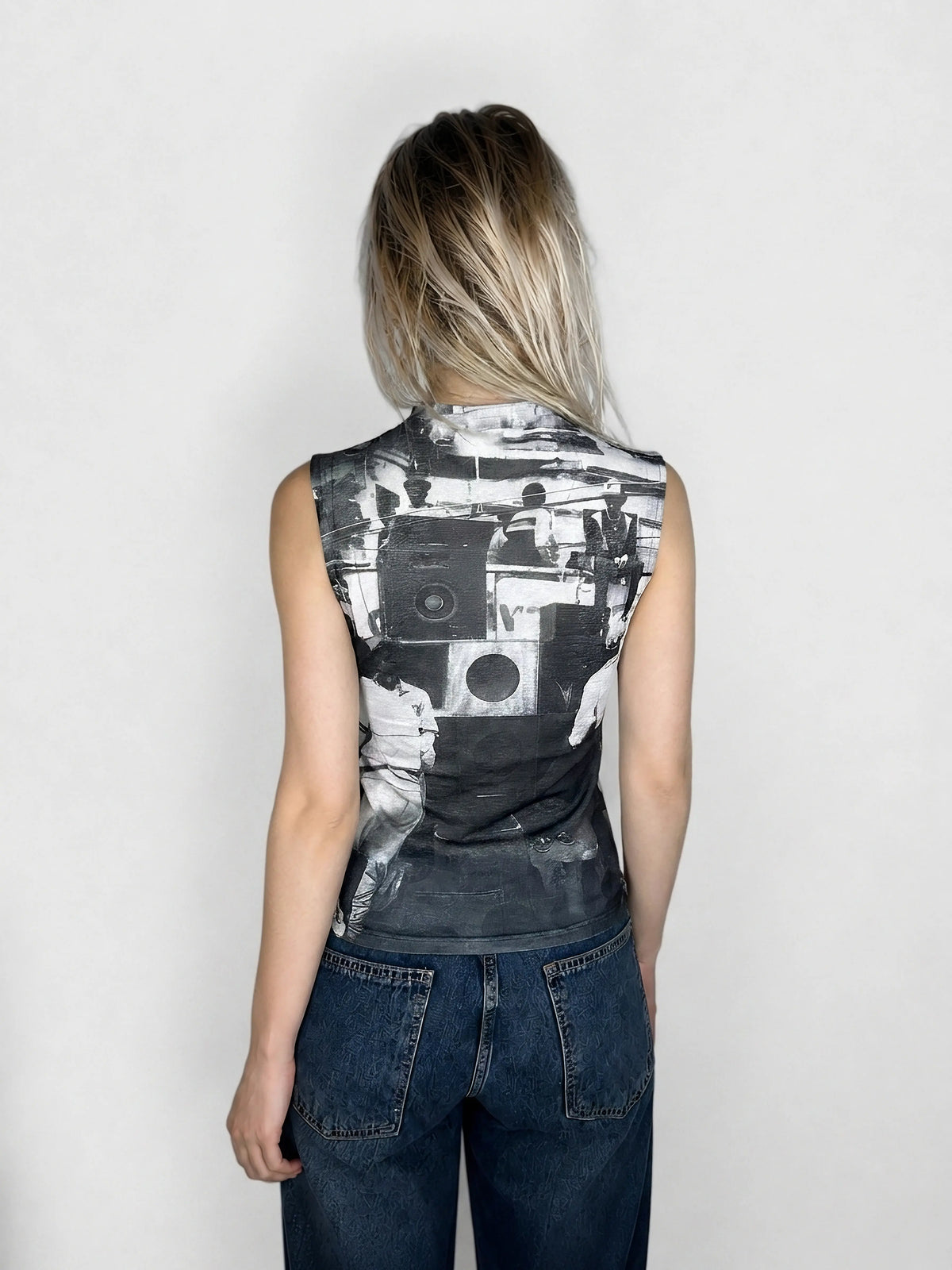 Back view of a graphic sleeveless top featuring a monochrome bold print.
