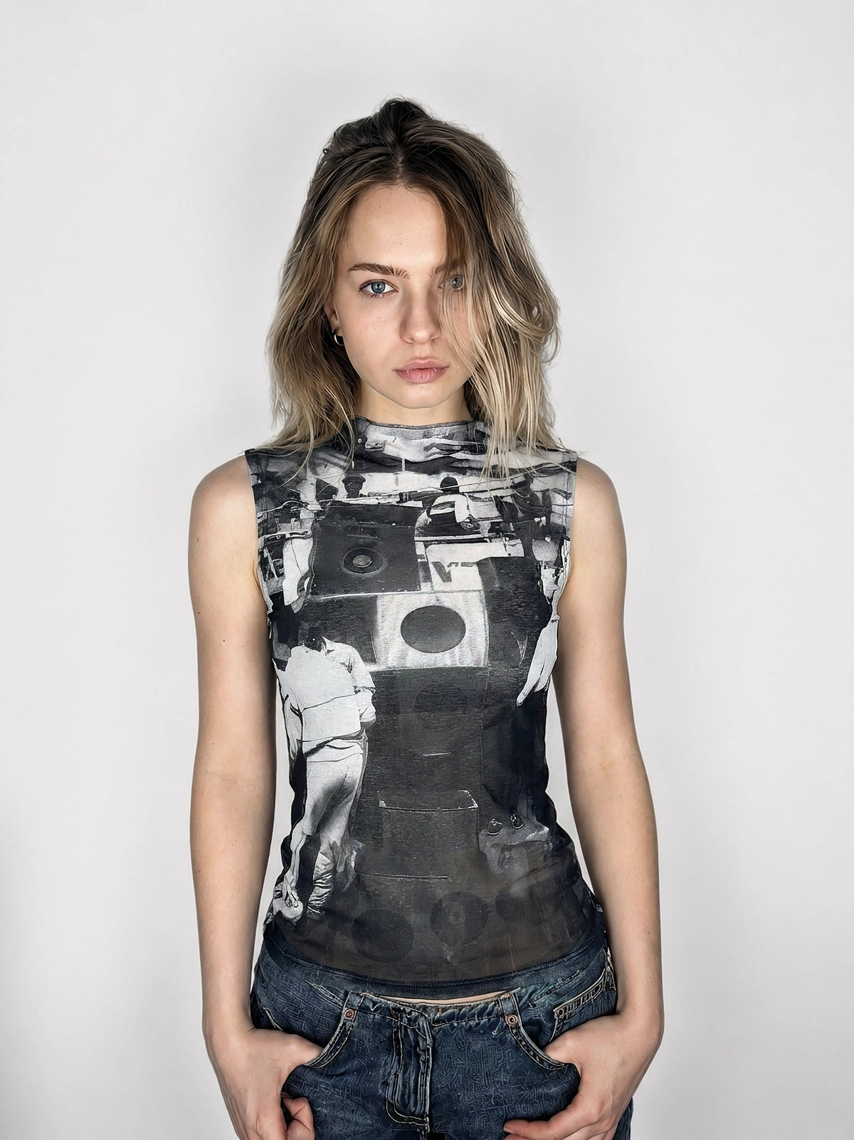 Front view of a sleeveless black graphic top with bold print.