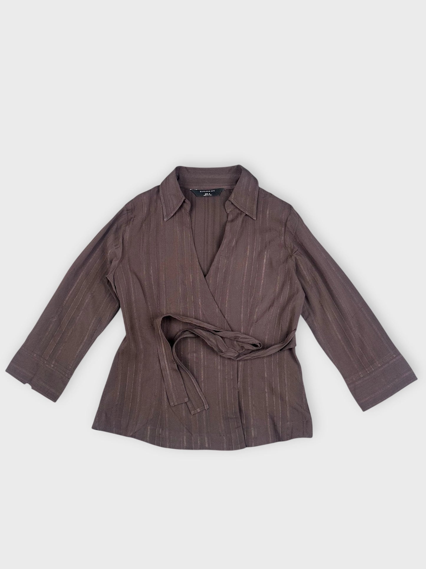 Brown wrap blouse front view with vertical stripes and self-tie detail.