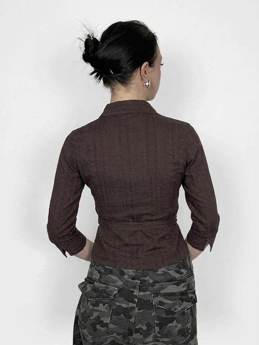 Back view of brown grunge wrap blouse with self-tie detail.