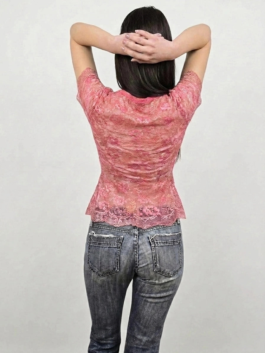Back view of a lace pink button-up top with satin ribbons.