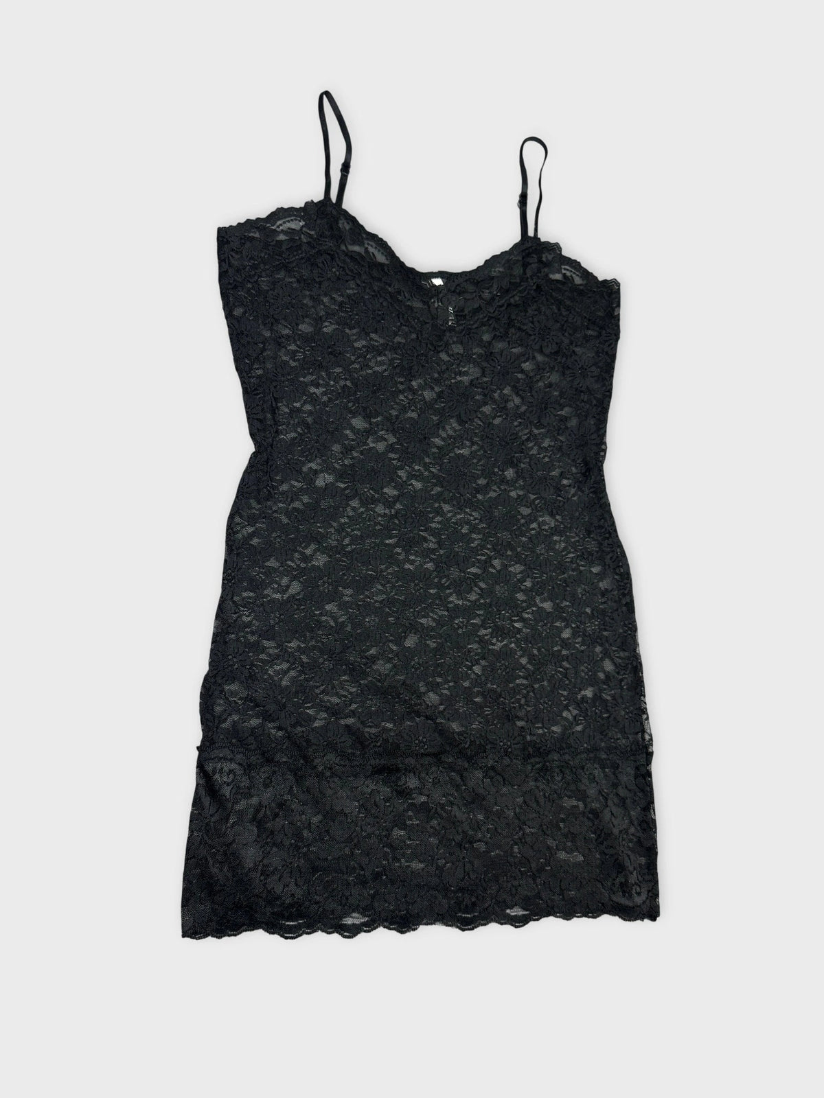 Detail view of a black lace cami top with floral design.