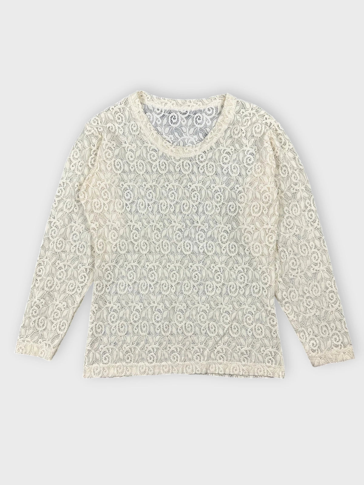 Lace long sleeve top in cream color with floral detail front view.