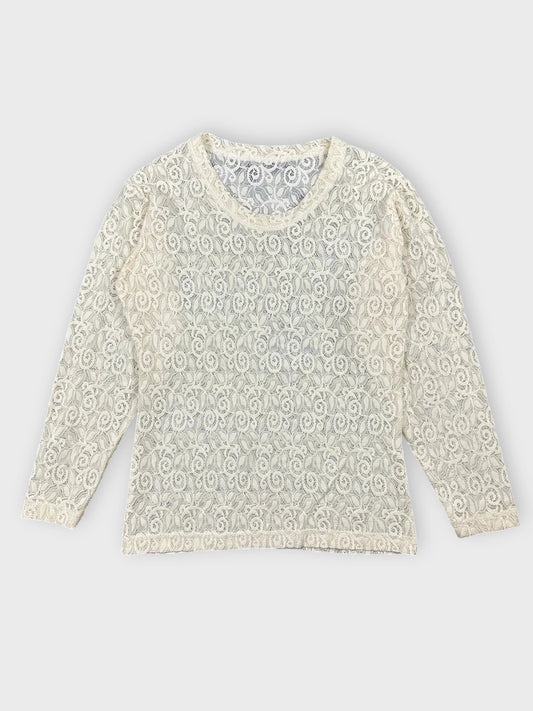 Lace long sleeve top in cream color with floral detail front view.
