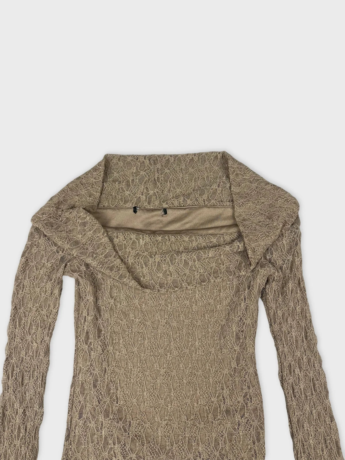 detail view of a beige lace long sleeve top with sheer detail