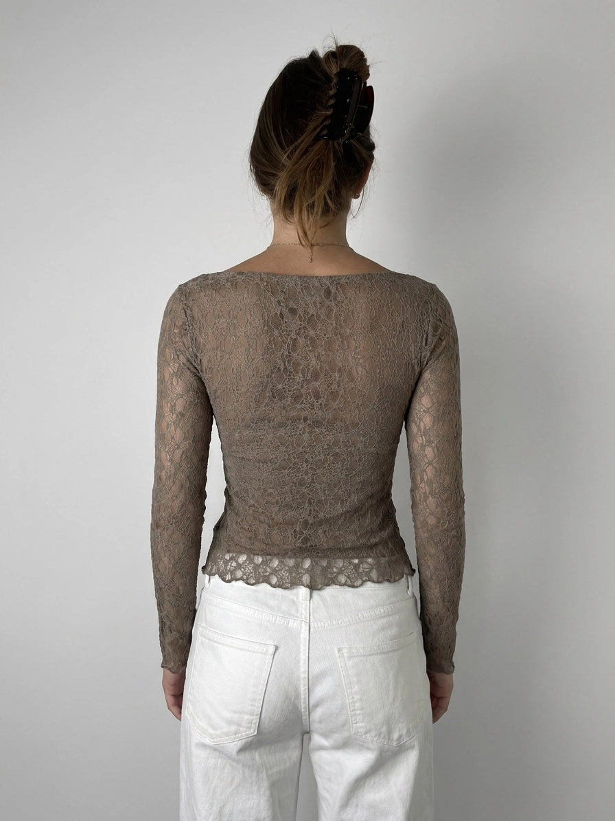 Back view of a lace long sleeve top in taupe with sheer detail.