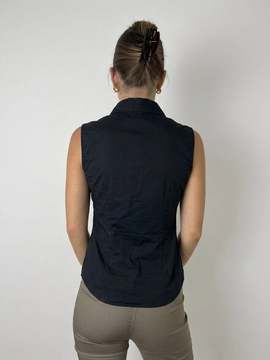 Back view of a black blouse featuring lace detail on the neckline.