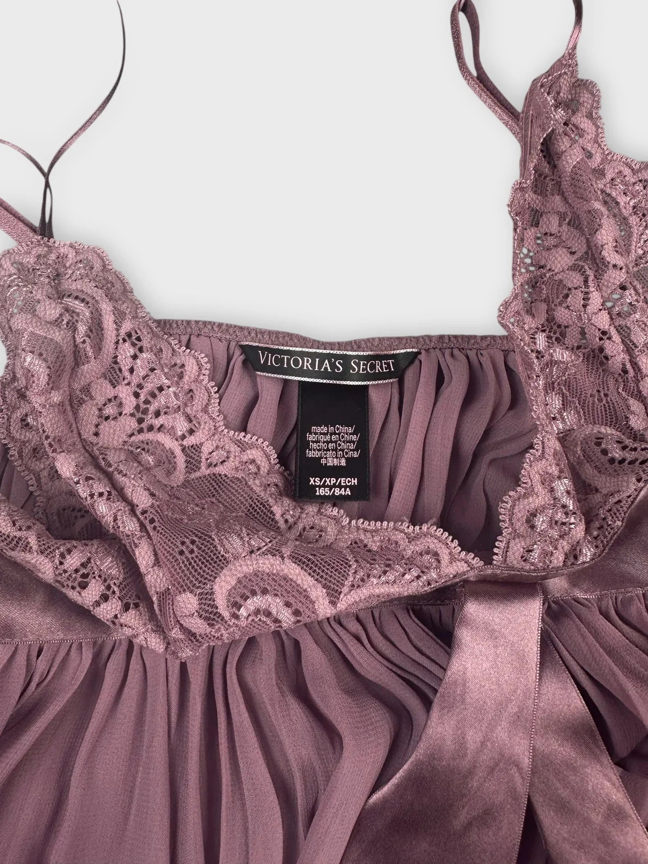 Detail view of lavender lace bralette with silk trim and delicate straps.