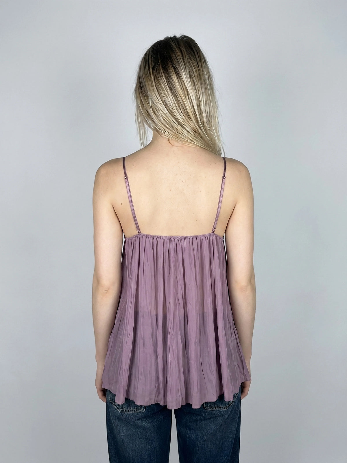 Back view of a lavender lace bralette featuring silk detailing and thin straps.