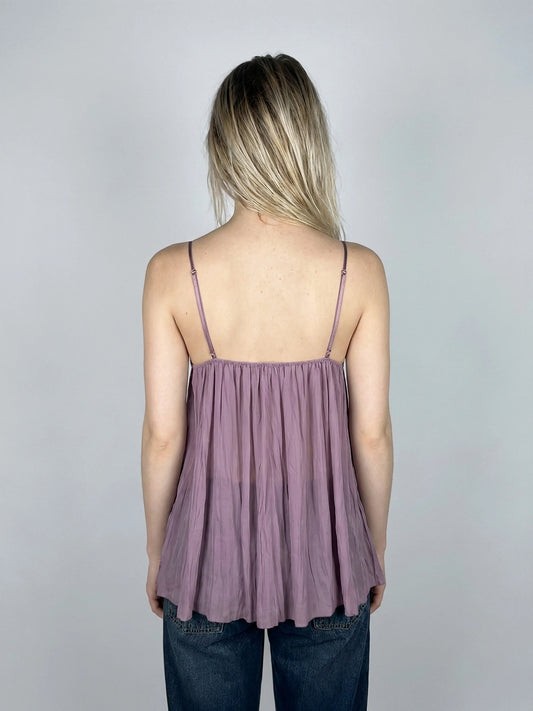 Back view of a lavender lace bralette featuring silk detailing and thin straps.