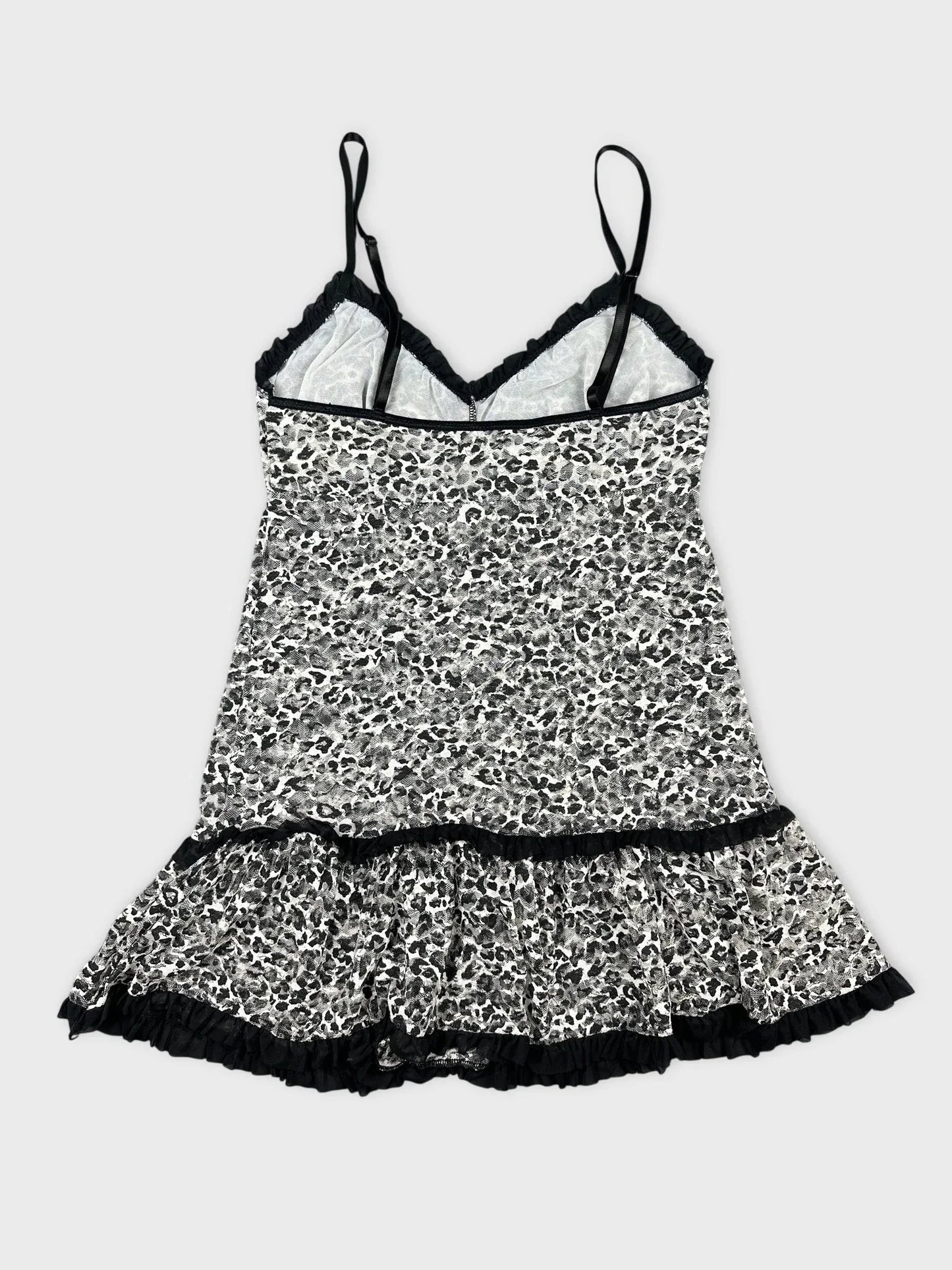 Back view of leopard print flare top with ruffled hem.