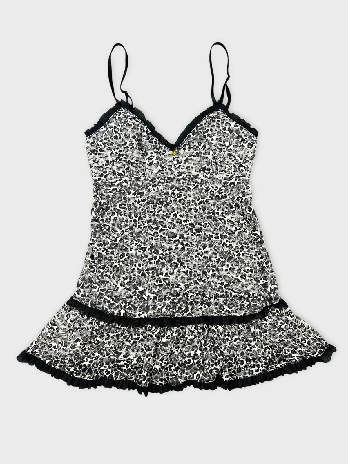 Leopard print flare top with ruffles front view featuring black trim details.