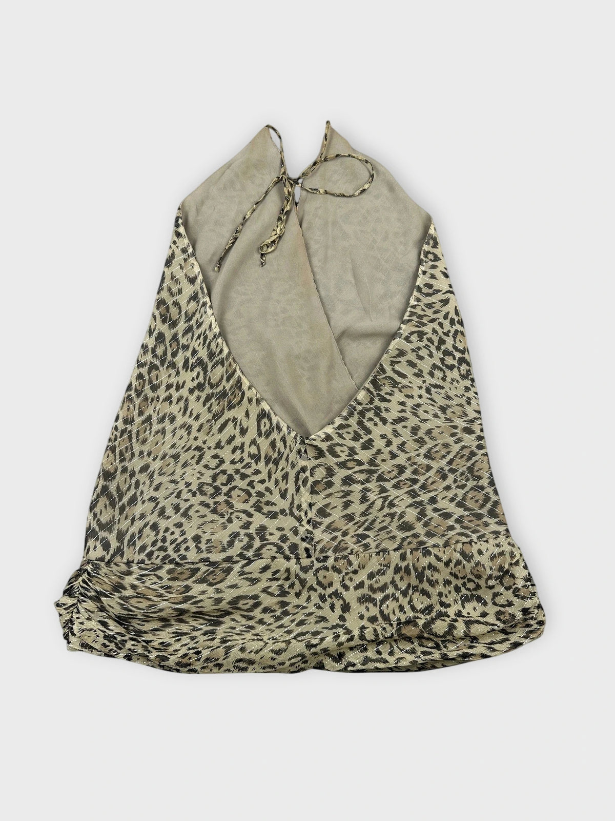 Back view of leopard print silk halter top featuring a loose flowing design.