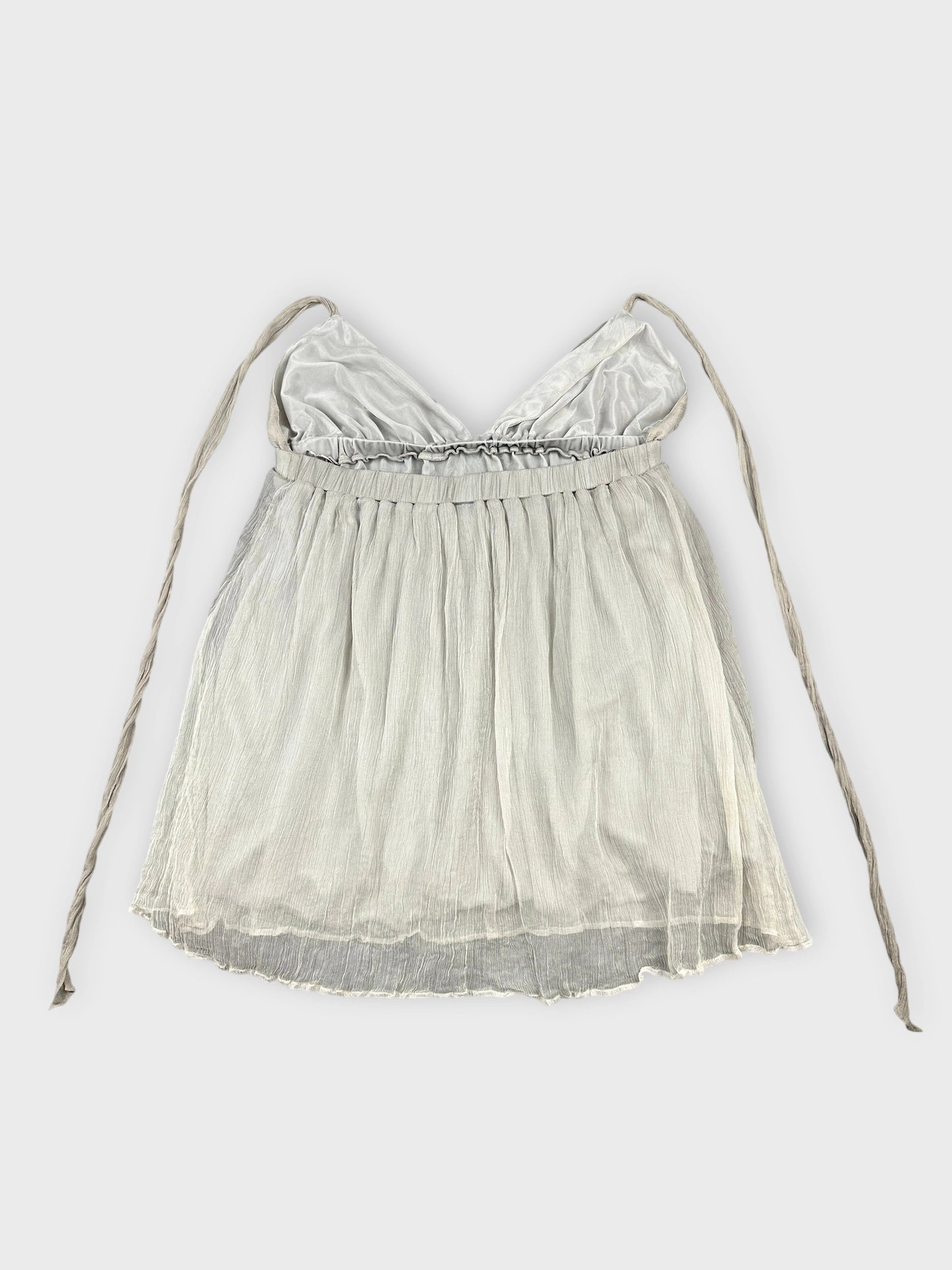 Light grey silk halter top with soft ruffles in back view.