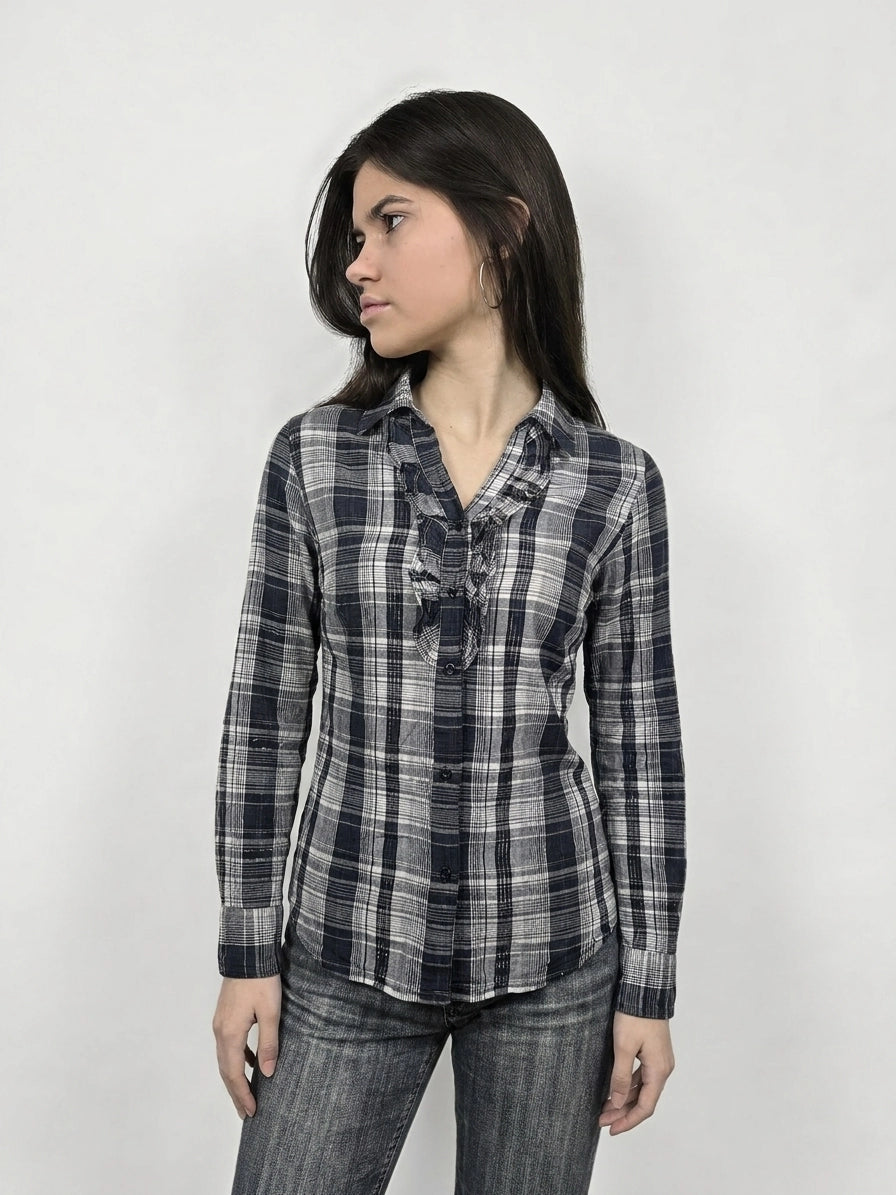 Front view of a longsleeve top in navy plaid with ruffle detail.