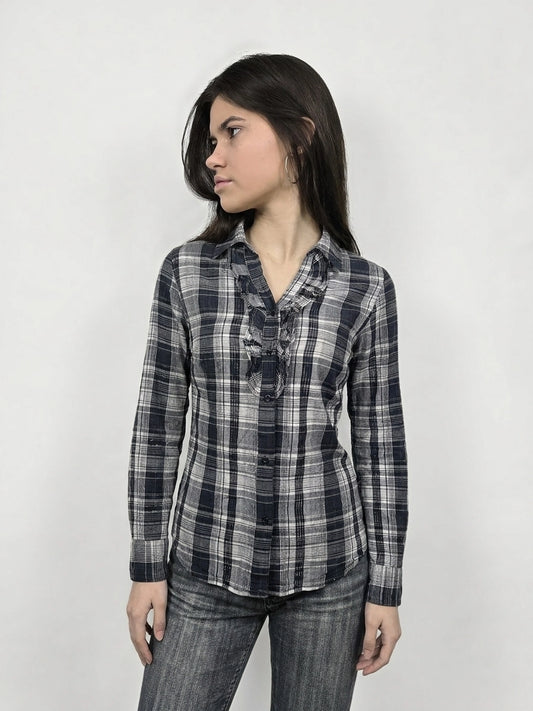 Front view of a longsleeve top in navy plaid with ruffle detail.