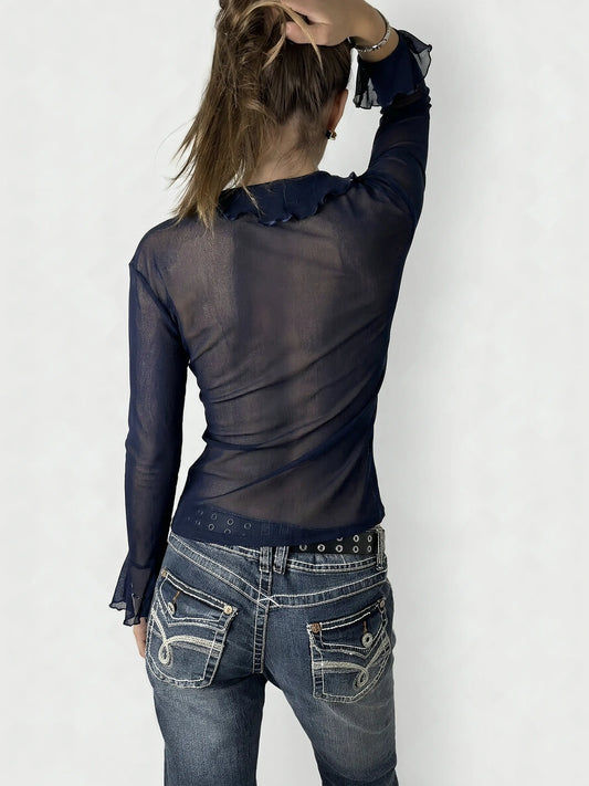 Back view of navy ruffled cardigan with ties and flared sleeves.