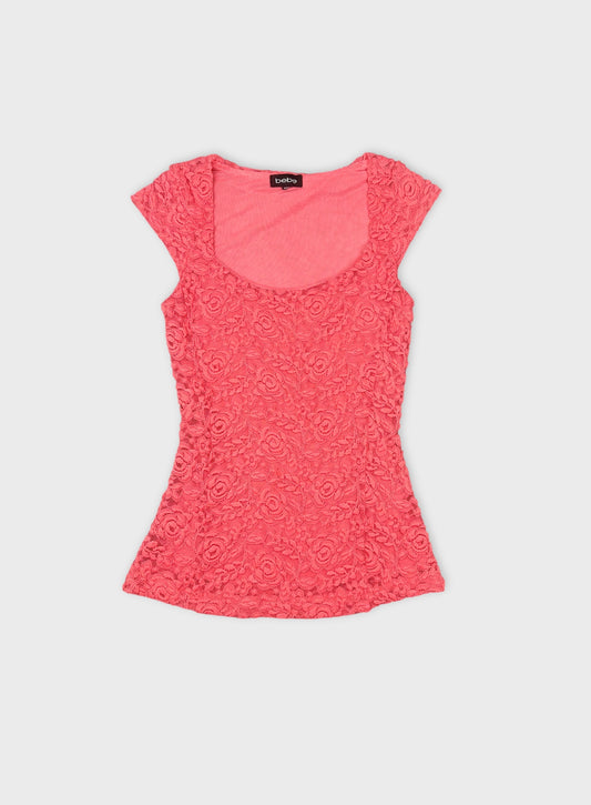 Front view of a pink floral lace crop top with a scoop neckline.