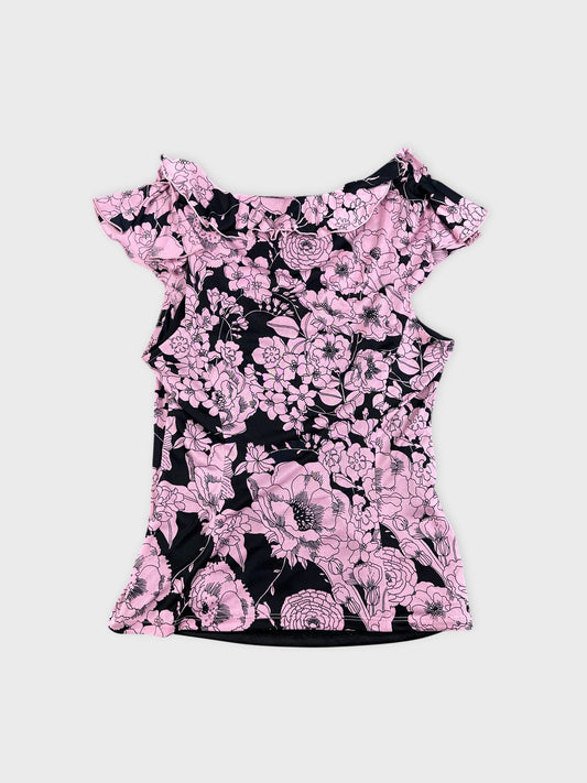 Back view of a pink floral vintage corset dress with ruffled shoulders.