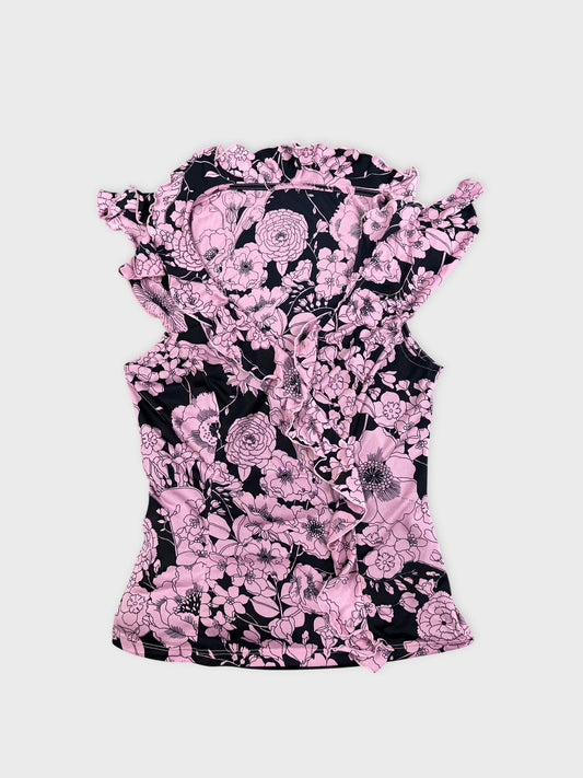 Pink floral vintage corset dress in a front view with ruffled trim.