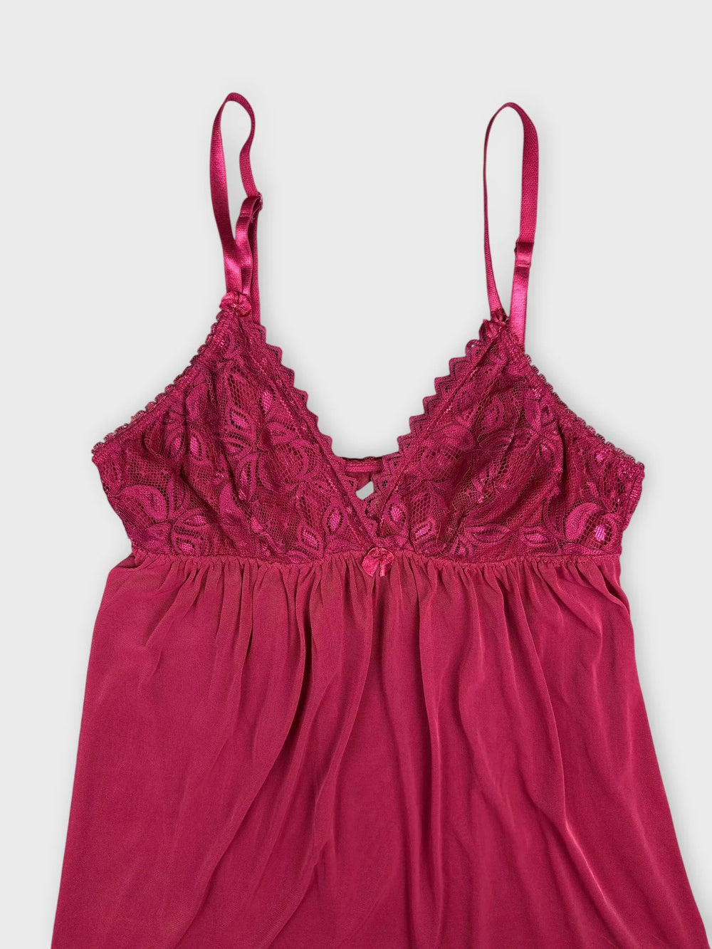 Front view of pink lace cami featuring floral lace detail on bodice