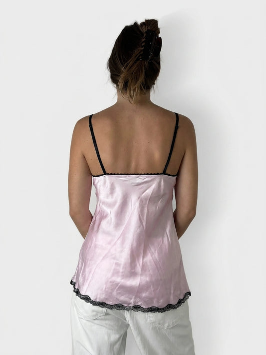 Back view of a pink satin camisole with black lace trim.
