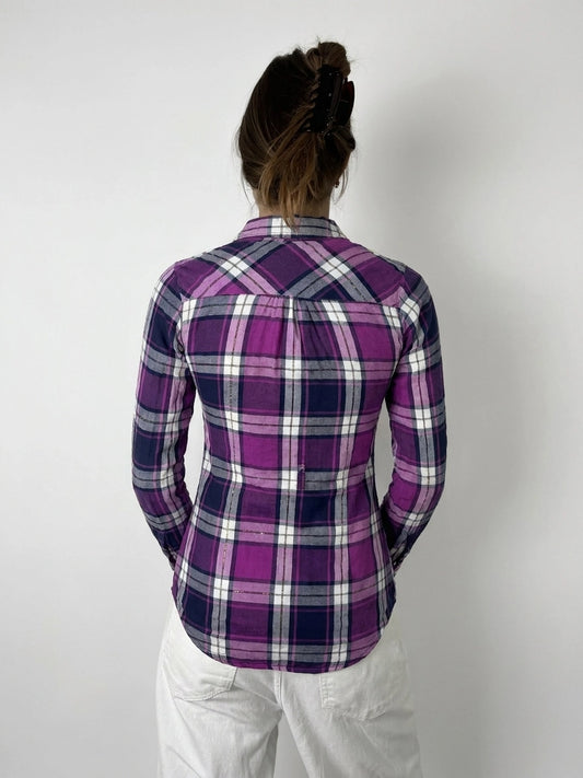 Back view of plaid button-up shirt in purple with unique cutout detail.