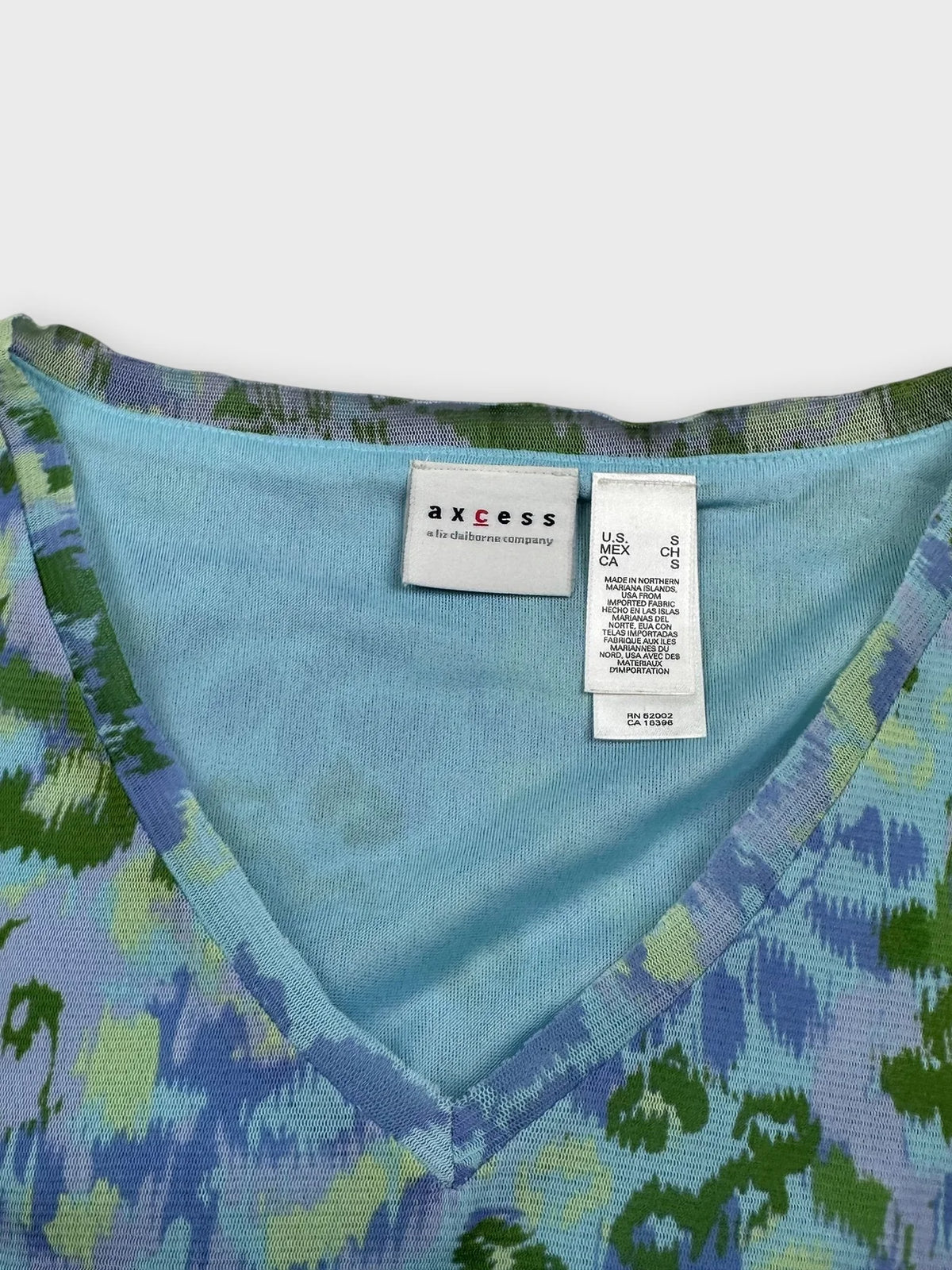 Detail view of a blue printed v-neck top with a flare hem.