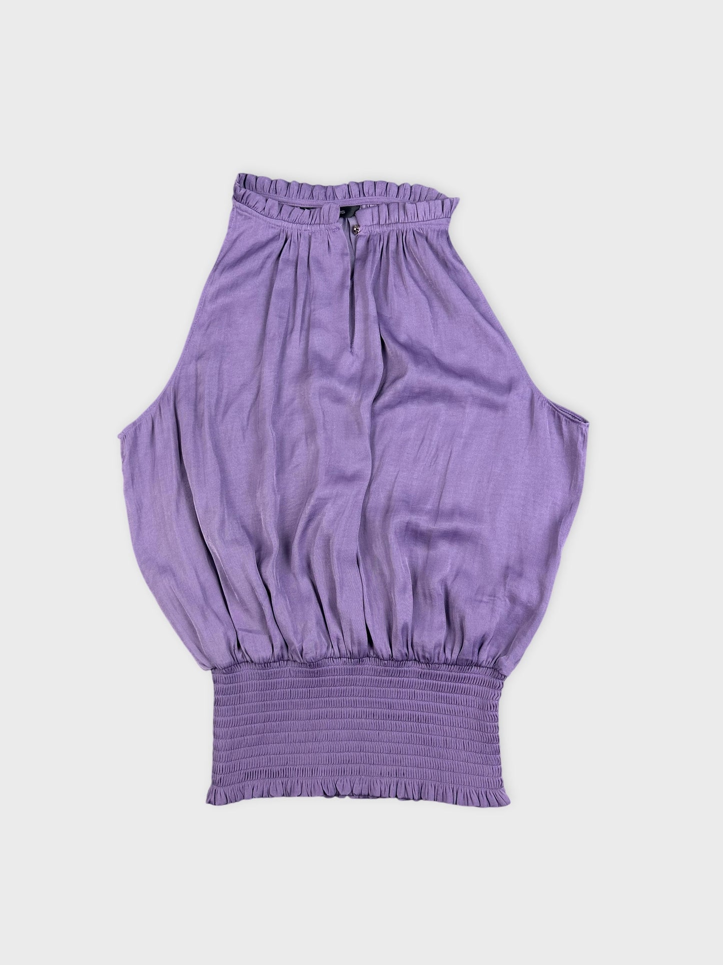 Detail view of a purple balloon top featuring smocked waist.