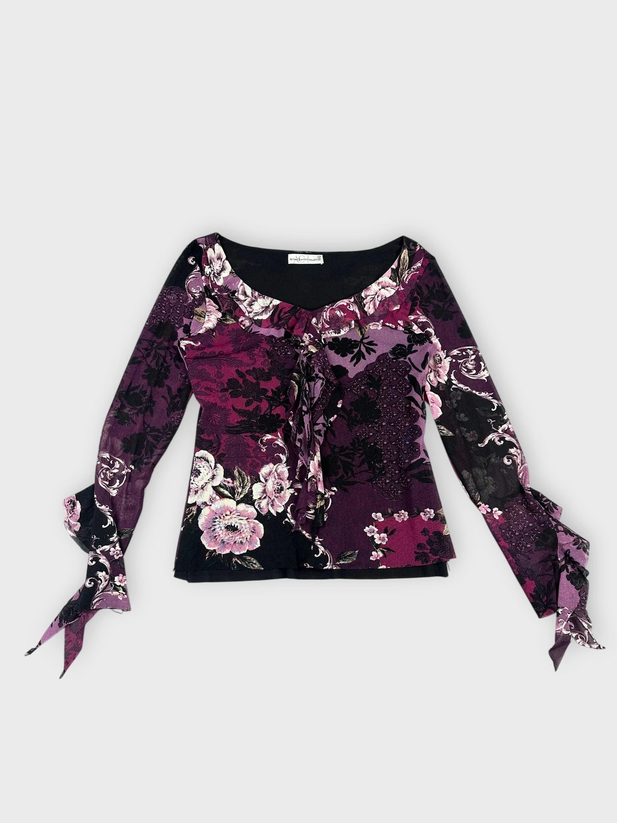 Front view of purple floral lace top with bell sleeves and floral pattern.