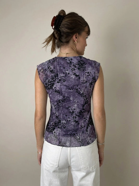 Back view of a purple floral lace top featuring a keyhole detail.