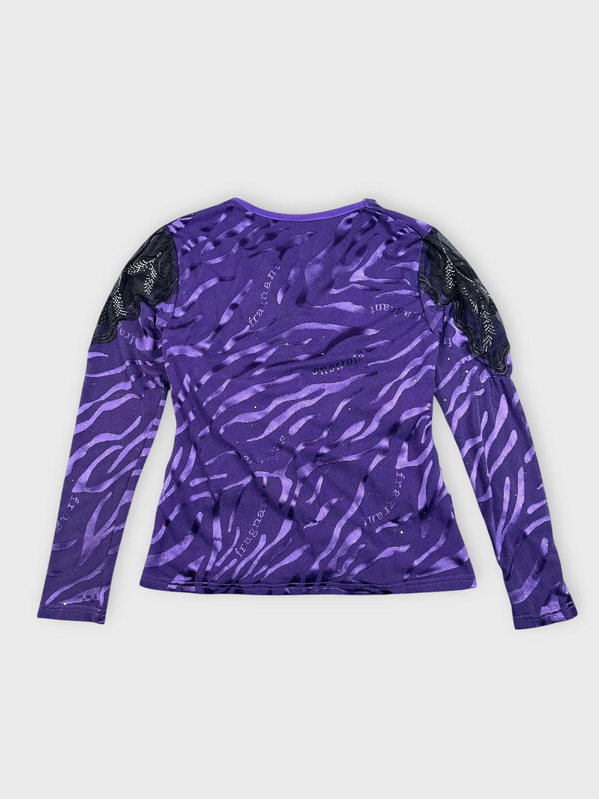 Back view of purple long sleeve top featuring black lace detail and zebra pattern.