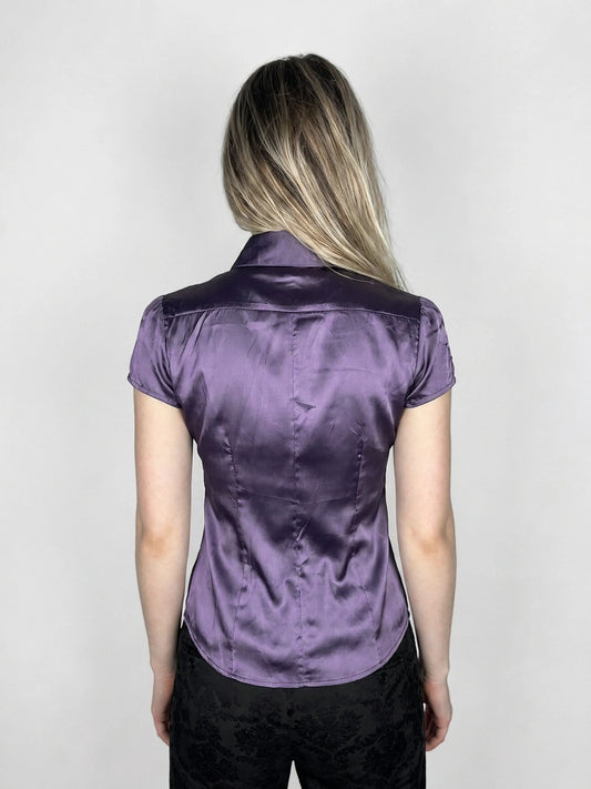 Back view of a purple satin button-up shirt with short sleeves.