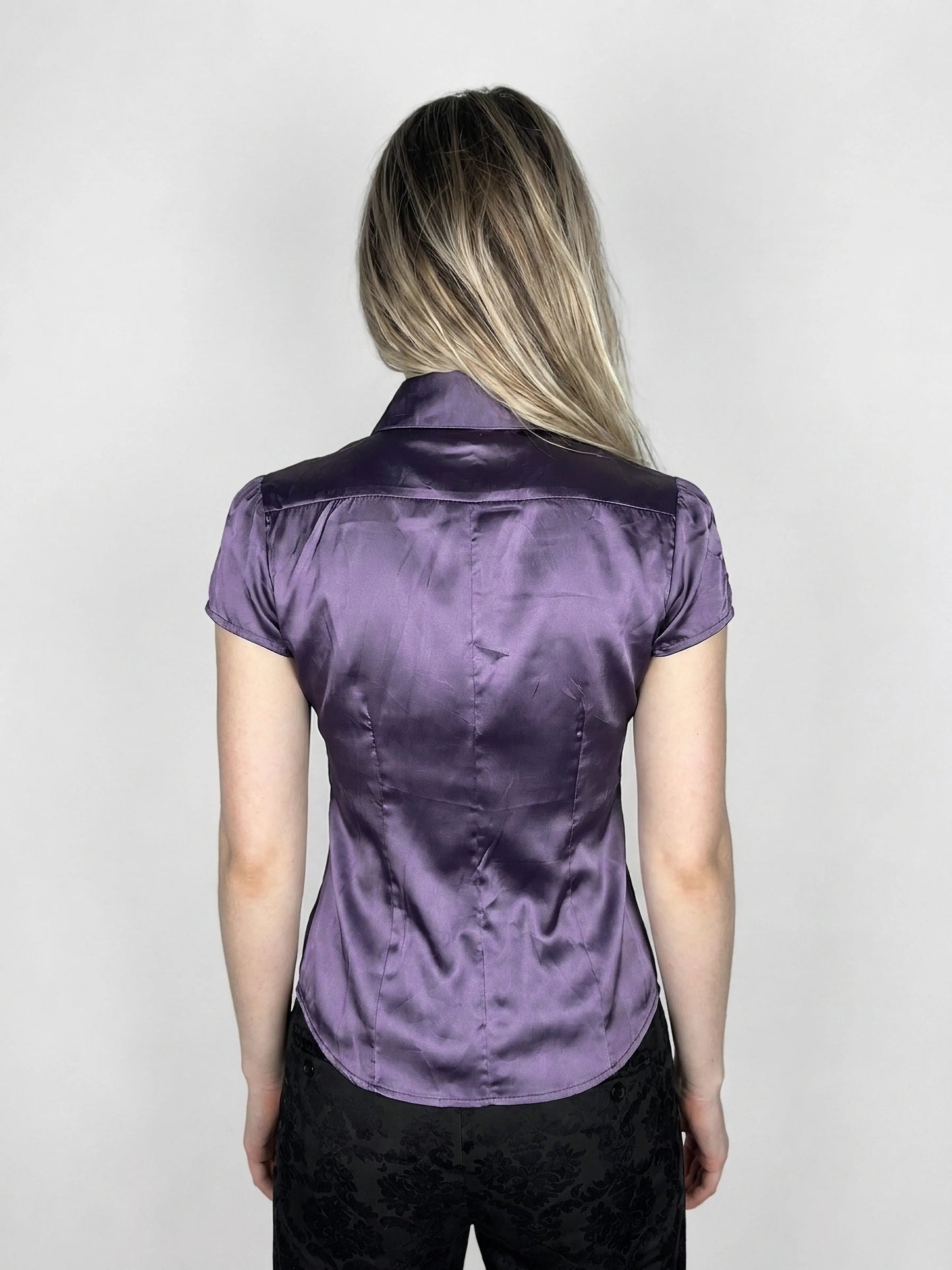 Back view of a purple satin button-up shirt with short sleeves.