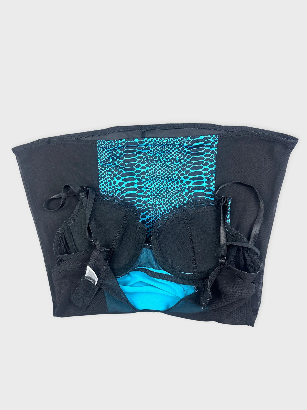 Detail view of a turquoise teal and black animal print bra.