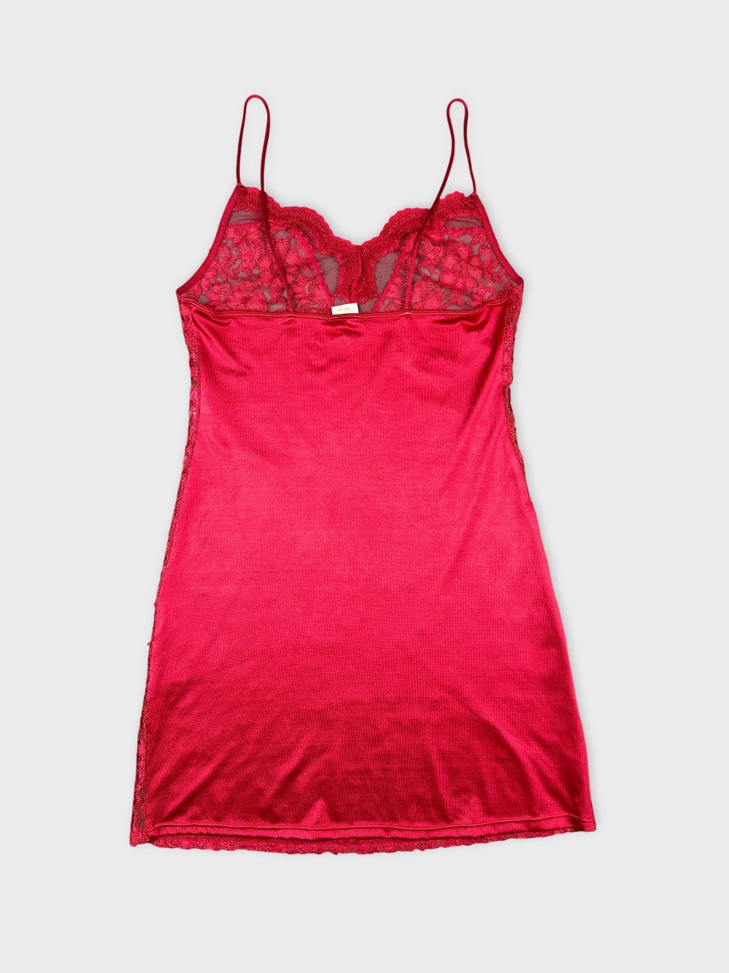 Back view of a red lace slip dress with adjustable straps.