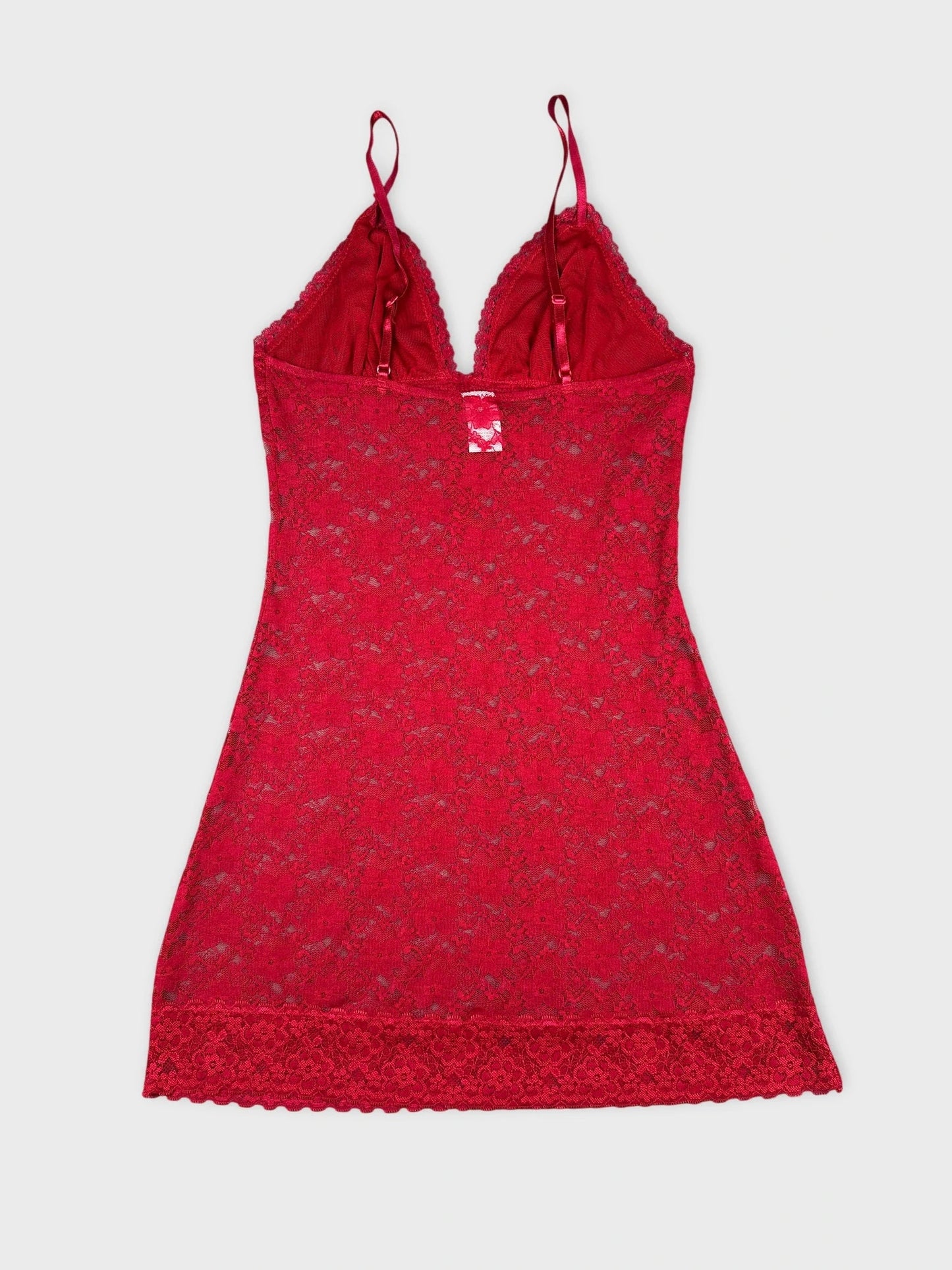 Back view of a red lace top with a sheer design and delicate straps.