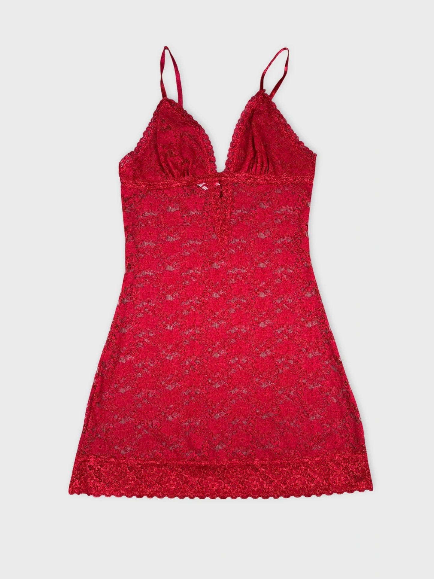 Red lace top with sheer design front view showcasing delicate lace trim.