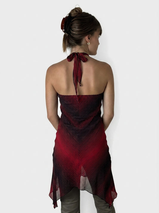 Back view of a red striped halter dress with a keyhole detail.