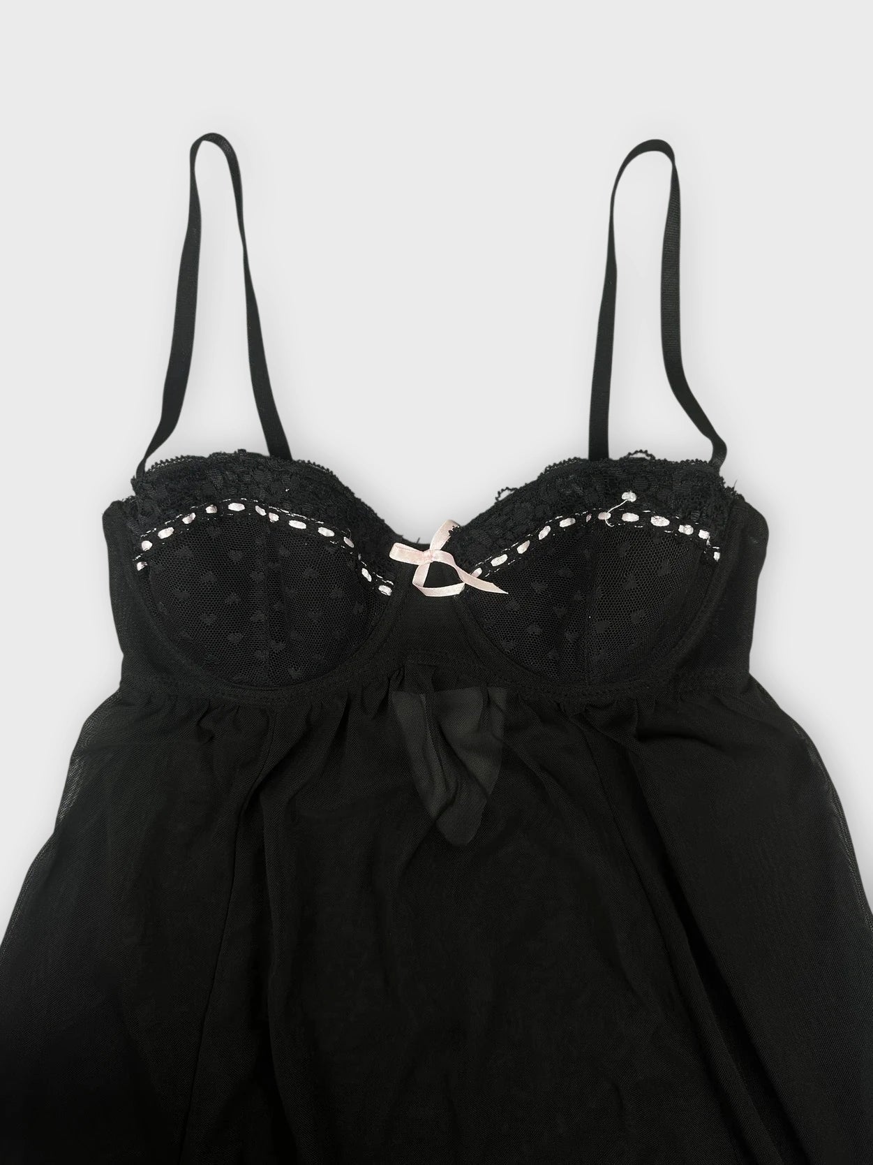 Sheer black babydoll top with pink trim detail view showing lace and thin straps.