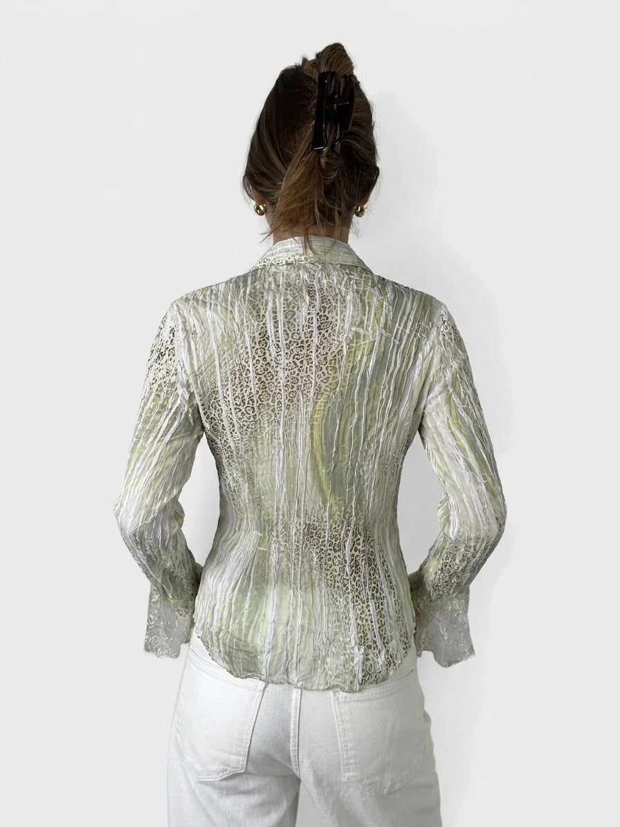 Back view of sheer green button-up top with lace sleeves and textured pattern.