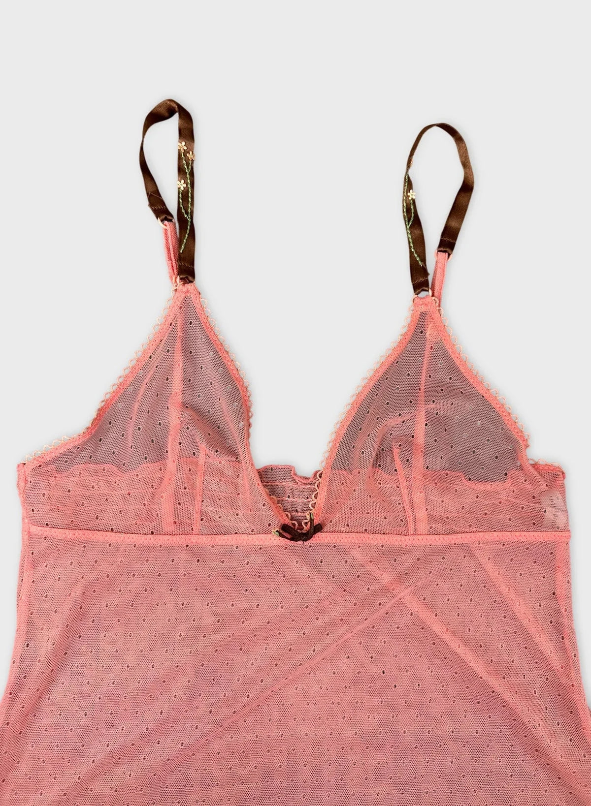 Sheer pink top with strappy detail view highlighting the V-neckline.